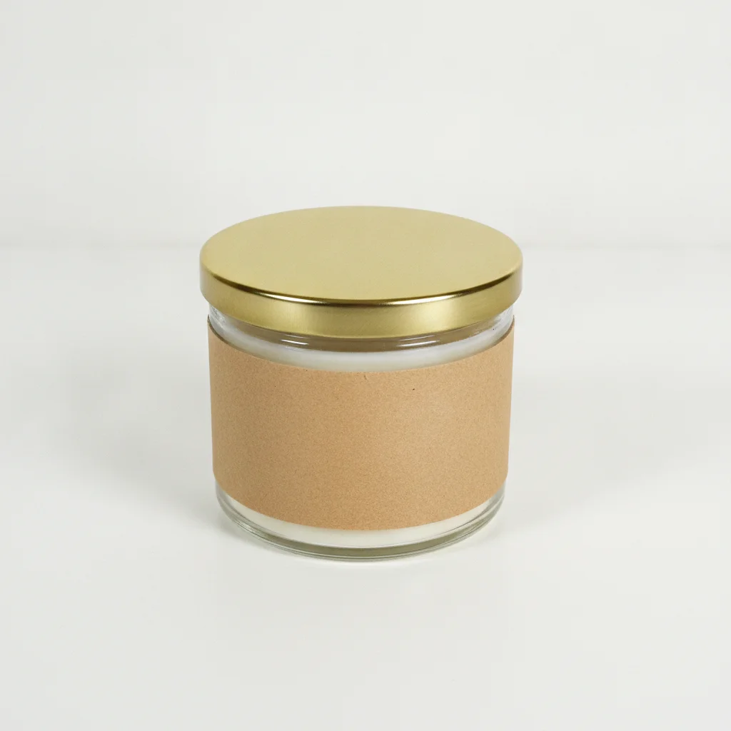 Glass candle jar on plain white table with flat overhead lighting