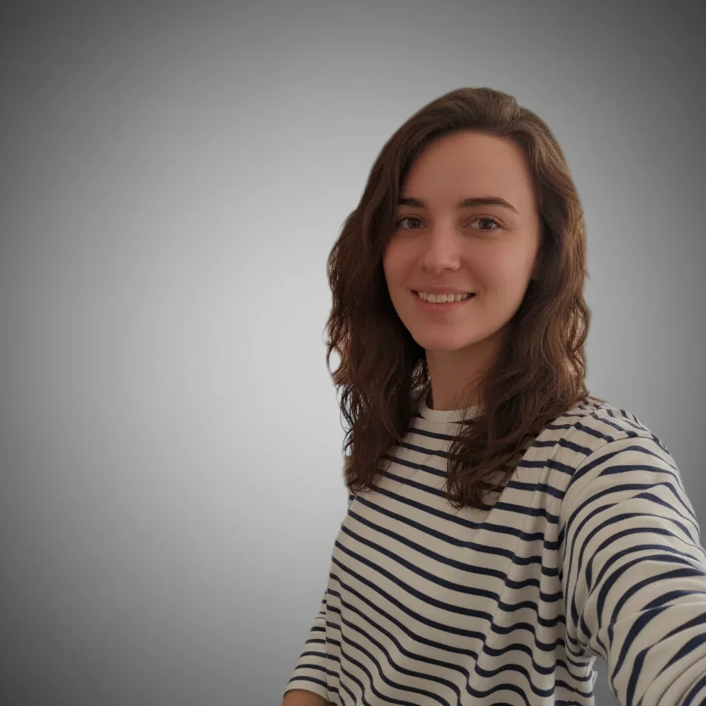 Professional headshot with blurred office background